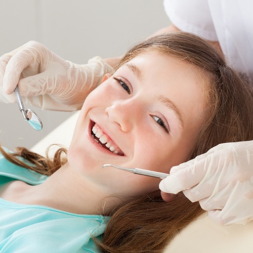 Smiling young girl during dental checkup