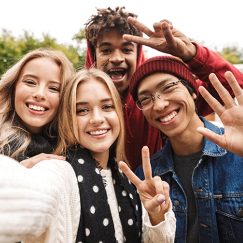 smiling teens taking a selfie together