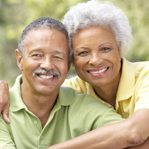 Older couple with dentures smiling together