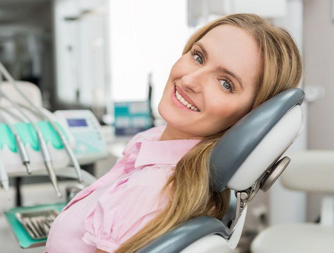 Woman smiling after pain relieving root canal therapy