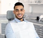 Man smiling while sitting in treatment chair