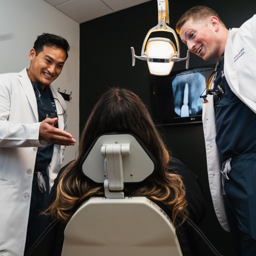 Three friendly smiling dental team members