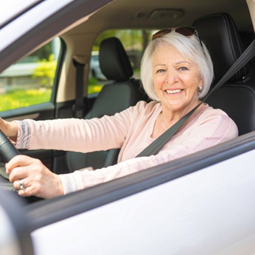 Happy mature woman driving  