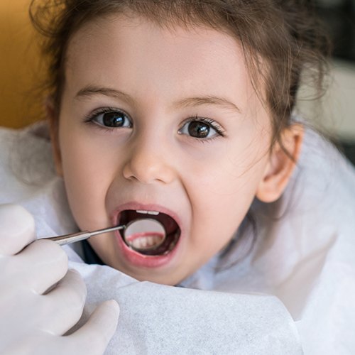 Child receiving dental sealant treatment