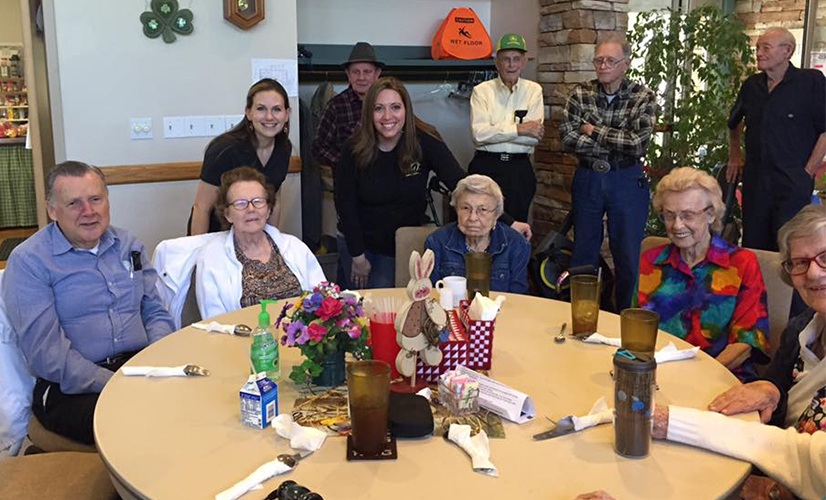 Legacy Dentistry team with group of seniors at community event