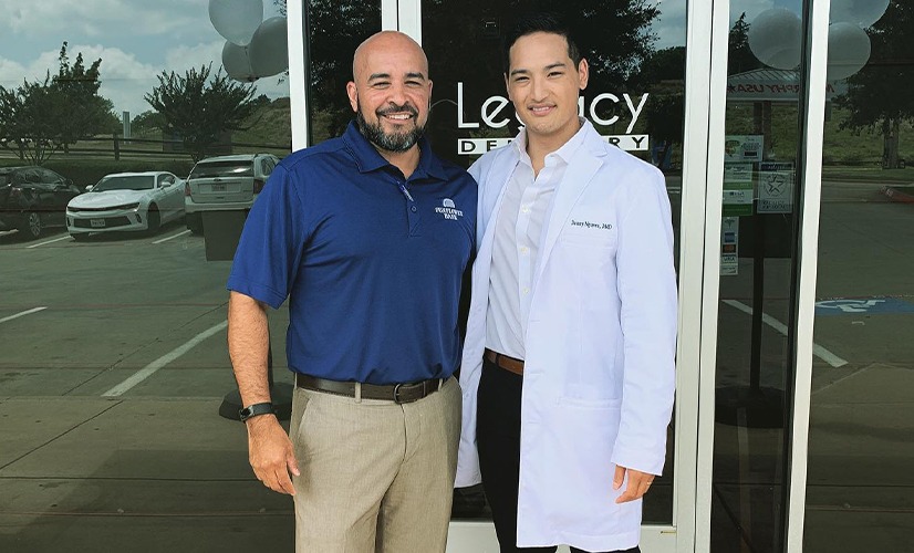 Dr. Nguyen and dental patient smiling in front of dental office