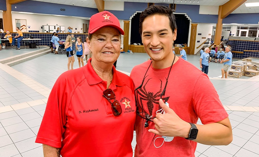 Dr. Nguyen and dental patient smiling together at school event