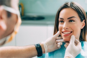 A cosmetic dentist assessing his patient