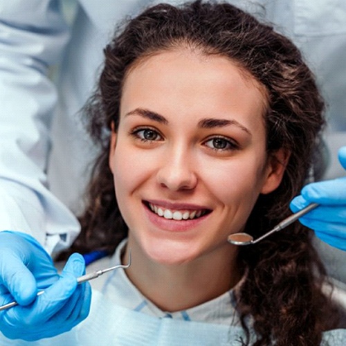 young woman smiling in the dental chair