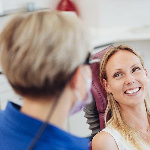 Woman smiling at dentist during dental appointment