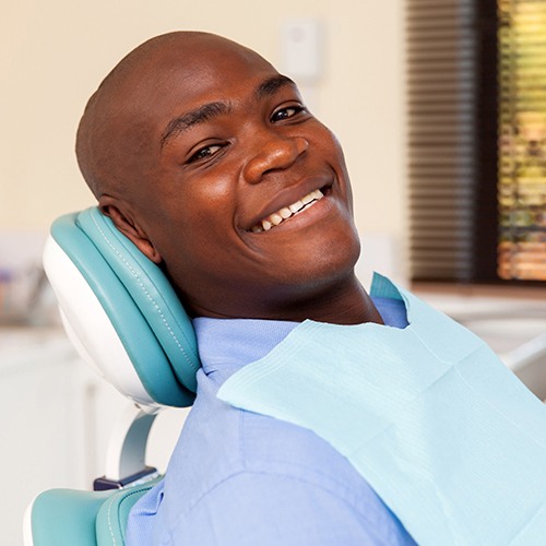 Man preventing dental emergencies in Midlothian by completing routine checkup