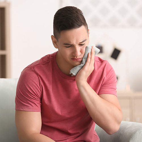 Young man in pain needs a tooth extraction