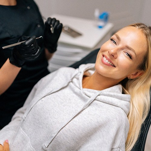 Patient reclined in treatment chair smiling