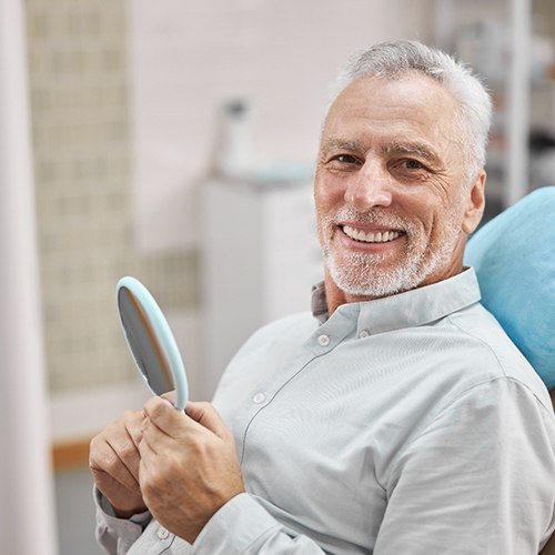 woman smiling and giving thumbs up