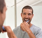 man brushing his teeth 