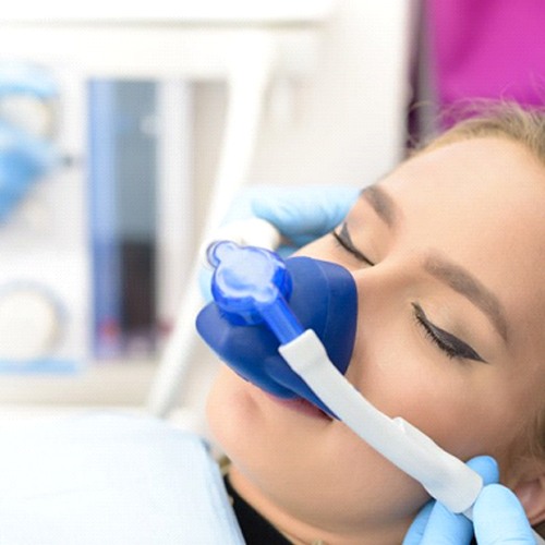 young woman wearing a nitrous oxide mask in the dental chair
