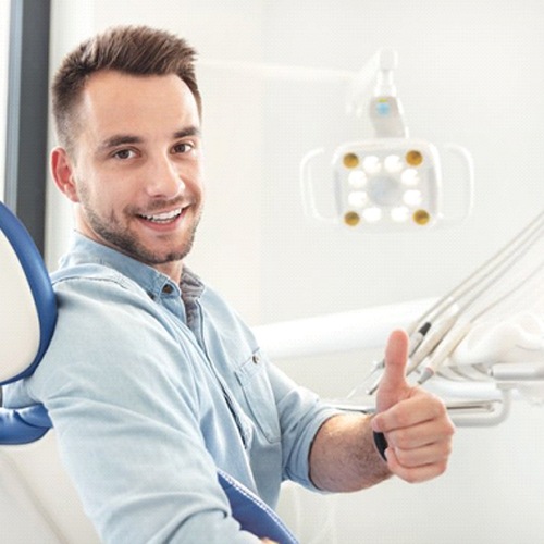 dental patient giving a thumbs up