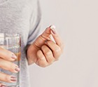 Woman holding a pill