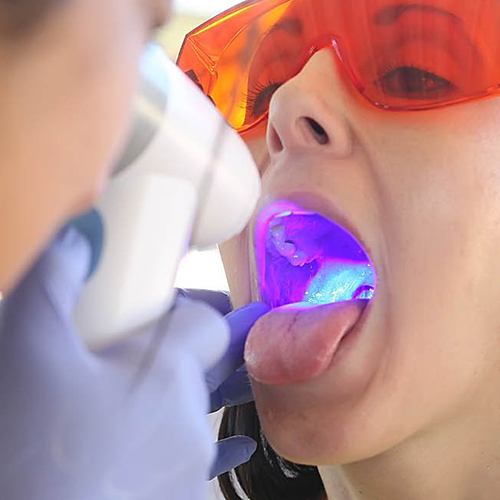 Woman receiving oral cancer screening