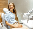 Female patient smiling at dentist at dental appointment