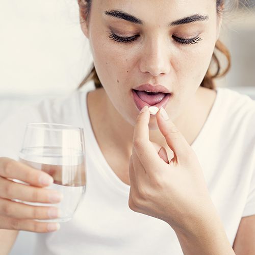 Woman taking oral conscious sedation pill