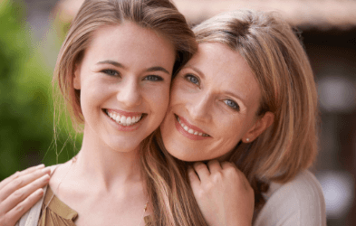 Mother and teen daughter with perfectly aligned smiles thanks to Invisalign