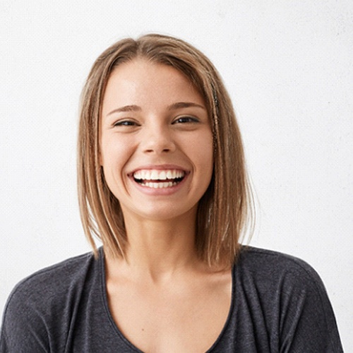 Woman smiling after visiting a cosmetic dentist in Midlothian