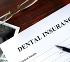 A dental insurance form sitting on a wood desk