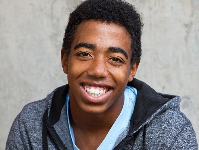 Teen boy smiling after wisdom tooth extraction