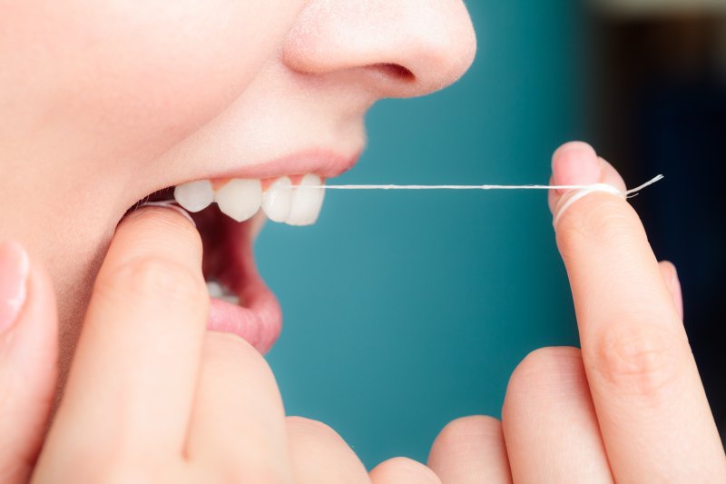 Woman using dental floss