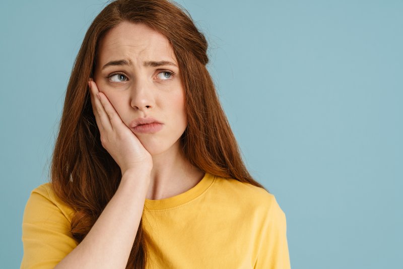 A woman with a tooth ache who needs a root canal treatment