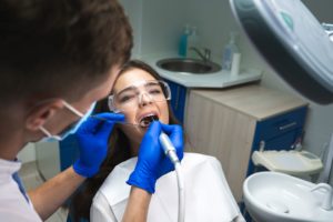 Dentist performing root canal on patient