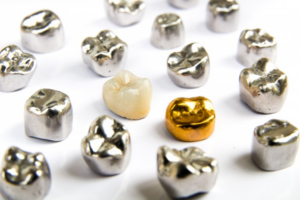 A scattering of dental crowns on a white surface